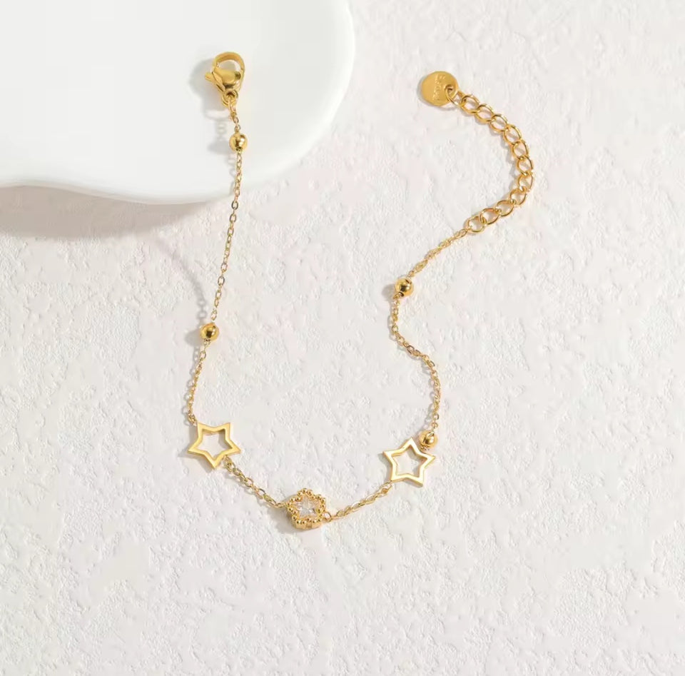 Un nouveau bracelet élégant en acier inoxydable au toucher luxueux, orné de motifs papillon, cœur, couronne et trèfle. Cette pièce unique et tendance constitue un cadeau idéal pour la famille, en particulier pour le Nouvel An.