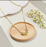 Collier en acier inoxydable doré, orné de cinq perles finement texturées. Un bijou délicat et lumineux, facile à porter au quotidien.