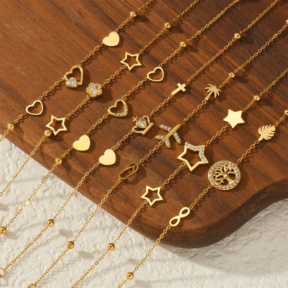 Un nouveau bracelet élégant en acier inoxydable au toucher luxueux, orné de motifs papillon, cœur, couronne et trèfle. Cette pièce unique et tendance constitue un cadeau idéal pour la famille, en particulier pour le Nouvel An.